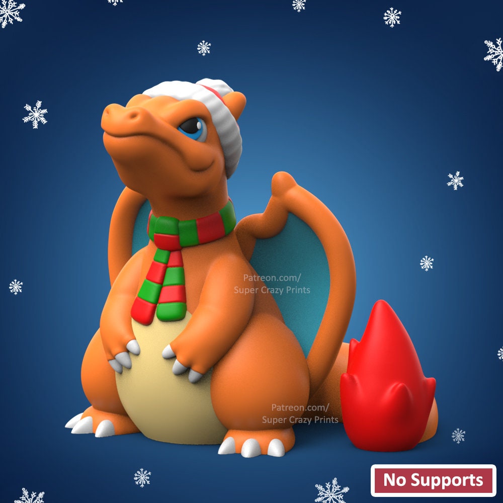 a toy dragon with a hat and scarf sitting in front of snowflakes