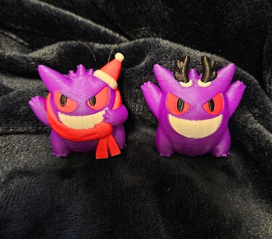 a couple of purple monsters sitting next to each other