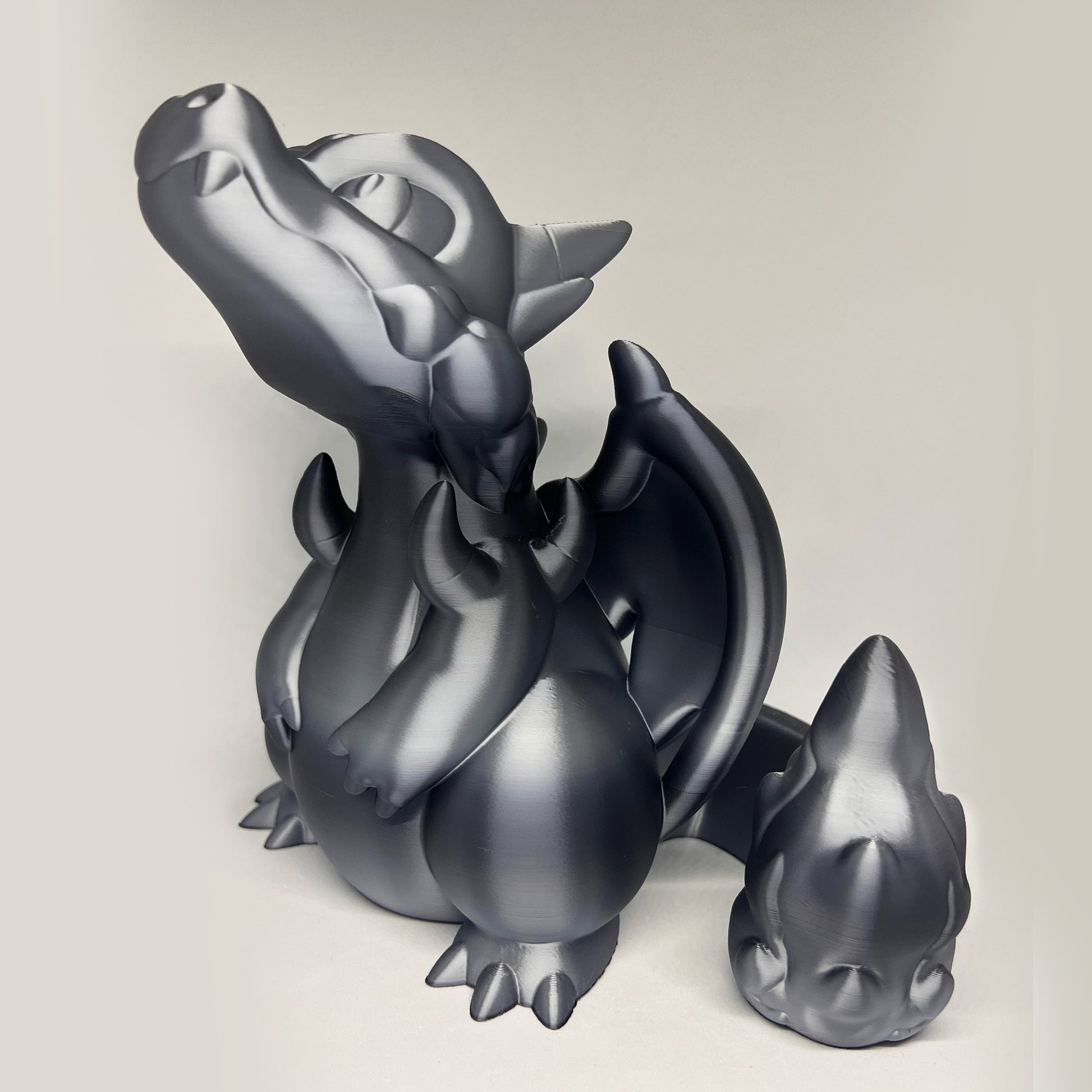 a metal sculpture of a dragon sitting on the ground