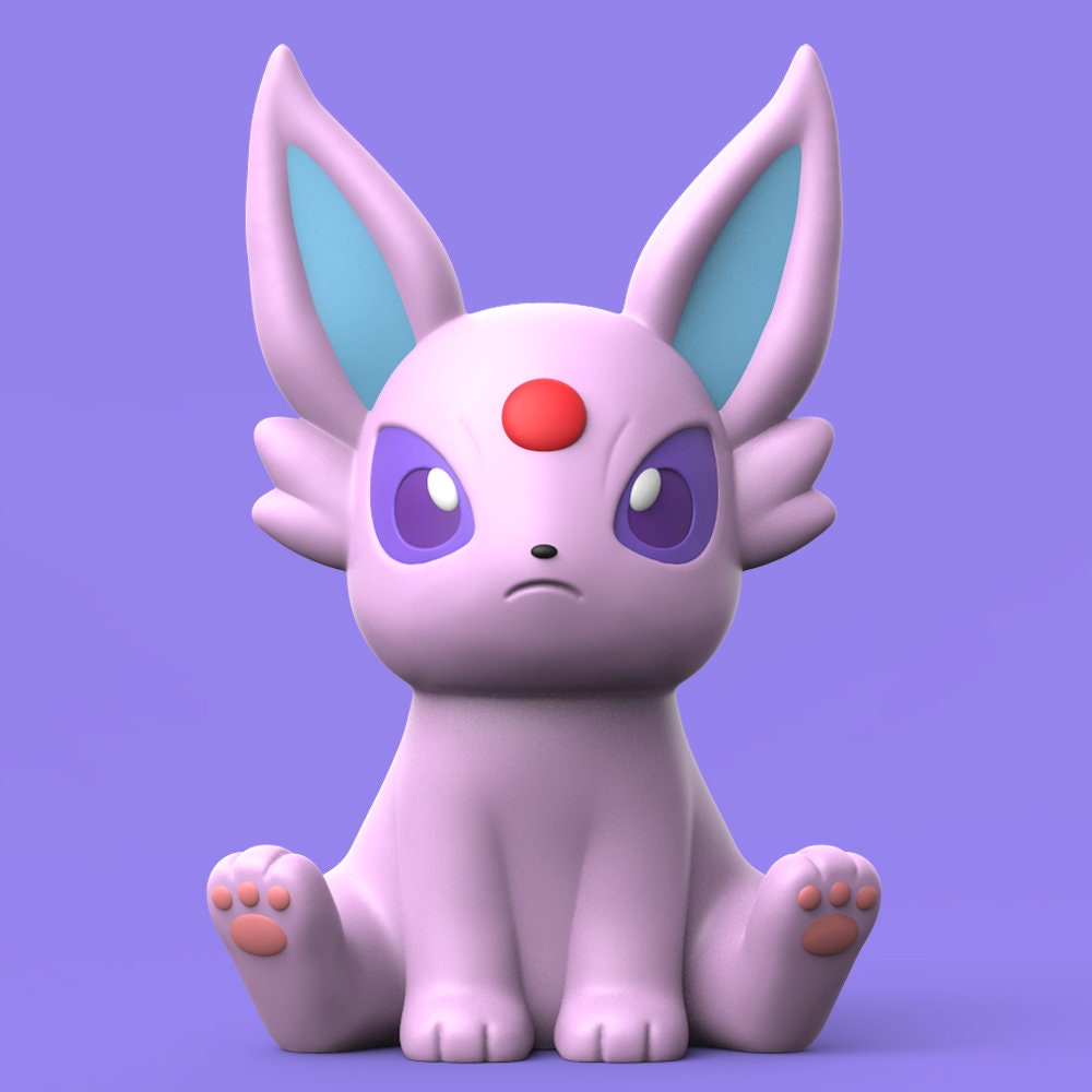 a pink and blue toy sitting on top of a purple surface